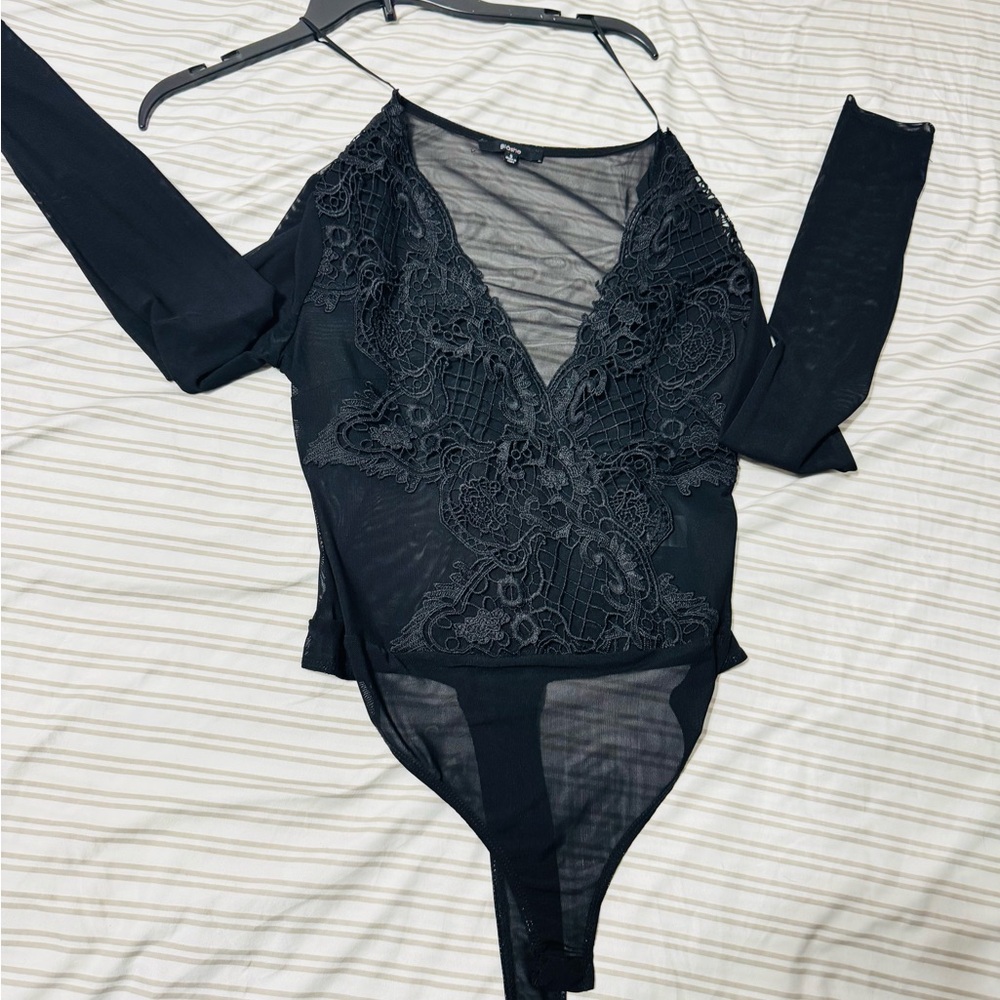 Long sleeve bodysuit with transparent fabric and sexy neckline.